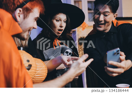 Friends enjoying a Halloween party at a bar making a toast Friends enjoying a Halloween party at a bar making a toast 134186444
