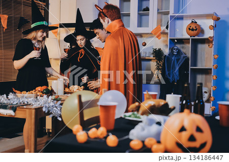 Friends enjoying a Halloween party at a bar making a toast Friends enjoying a Halloween party at a bar making a toast 134186447