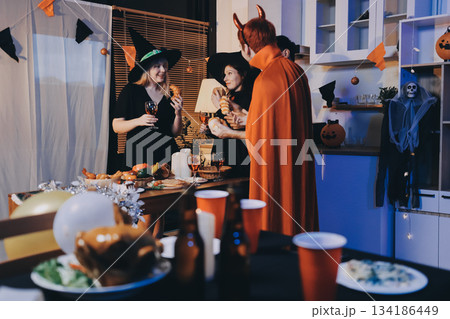 Friends enjoying a Halloween party at a bar making a toast Friends enjoying a Halloween party at a bar making a toast 134186449