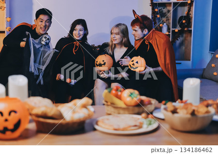 Friends enjoying a Halloween party at a bar making a toast 134186462
