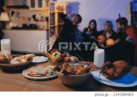 Friends enjoying a Halloween party at a bar making a toast Friends enjoying a Halloween party at a bar making a toast 134186463