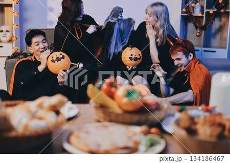 Friends enjoying a Halloween party at a bar making a toast 134186467