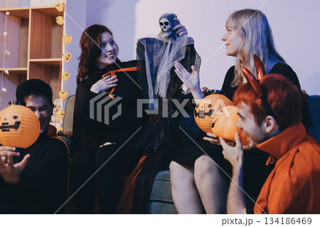 Friends enjoying a Halloween party at a bar making a toast Friends enjoying a Halloween party at a bar making a toast 134186469