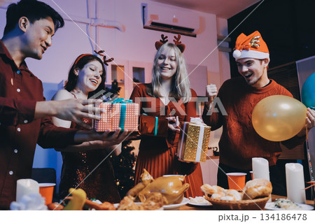 Festive Office Christmas Party with Delicious Food. A beautifully decorated office space with Christmas trees and festive lights, set up for a holiday party. 134186478