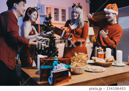 Festive Office Christmas Party with Delicious Food. A beautifully decorated office space with Christmas trees and festive lights, set up for a holiday party. 134186483