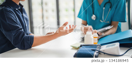 A patient explaining to a doctor. A patient explaining to a doctor. 134186945