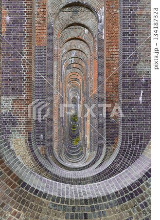 Architectural splendour of Ouse Valley Viaduct or Balcombe Viaduct (Railway viaduct) carries the Brighton Main Line over the River Ouse in Sussex. The semi-circular arches vaulting supporting brick 134187328