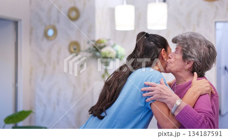 Grandmother and granddaughter embracing with love in nursing home Grandmother and granddaughter embracing with love in nursing home 134187591