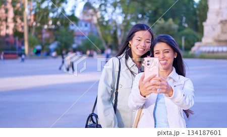 Diverse young women taking selfie together outdoors Diverse young women taking selfie together outdoors 134187601