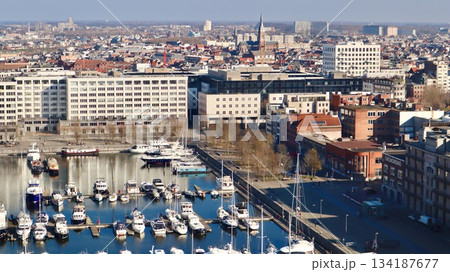 Antwerp city waterfront marina aerial view, boats moored along the docks, historic architecture in background 134187677