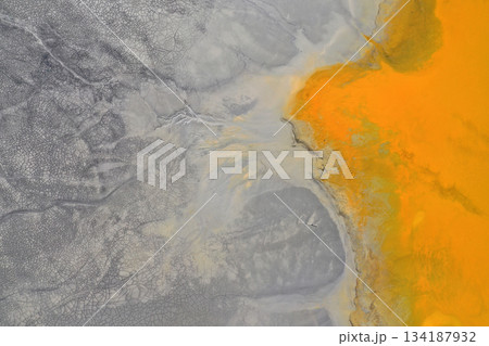 Flying over surreal patterns of flowing colorful mining chemical residuals aerial Flying over surreal patterns of flowing colorful mining chemical residuals aerial 134187932