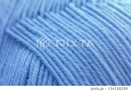 Close-up Texture of Blue Wool Thread. Winter yarn in a ball background. 134188289