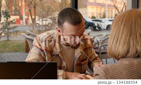 Collaboration between two people using a laptop and discussing a project Collaboration between two people using a laptop and discussing a project 134188354