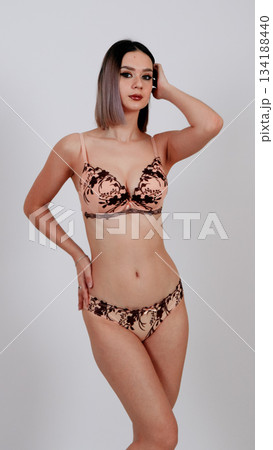 Attractive woman in floral lace lingerie set, dynamic pose 134188440