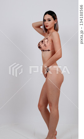 Full-length back view of woman in floral lace lingerie and heels Full-length back view of woman in floral lace lingerie and heels 134188566