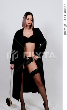 Fashionable woman in black lingerie and a long, dramatic cardigan Fashionable woman in black lingerie and a long, dramatic cardigan 134188836