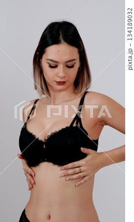 Side view of a confident young woman in simple black bra and panties Side view of a confident young woman in simple black bra and panties 134189032