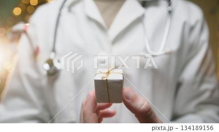 Anonymous Doctor Gives a Small Christmas Gift Box to His Patients Anonymous Doctor Gives a Small Christmas Gift Box to His Patients 134189156
