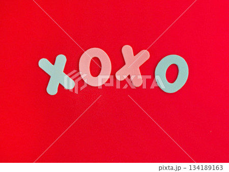 The inscription xo xo from colored letters on a red background. The concept of Valentine's day, love, dating and wedding. Kiss symbol. The inscription xo xo from colored letters on a red background. The concept of Valentine's day, love, dating and wedding. Kiss symbol. 134189163
