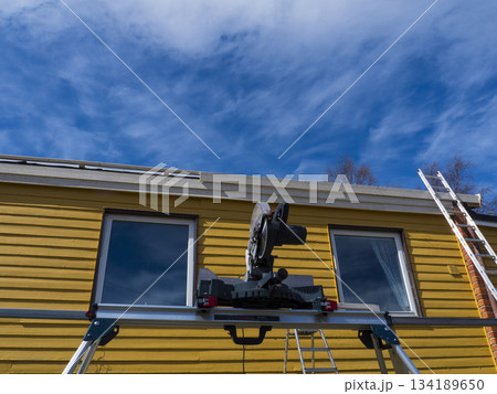 New residential construction wooden house framing against a blue sky 134189650