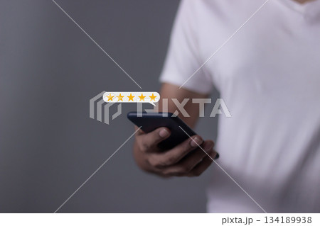Review Customer, Young Man hand using smartphone mobile with five star to review and give 5 stars with very good results in service, Good review 5 star rating choice feedback Review Customer, Young Man hand using smartphone mobile with five star to review and give 5 stars with very good results in service, Good review 5 star rating choice feedback 134189938