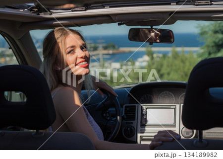 Young driver woman behind steering wheel 134189982