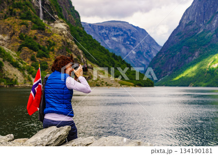Tourist with camera on fjord, Norway 134190181