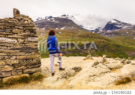 Tourist with camera in Norway mountains 134190182
