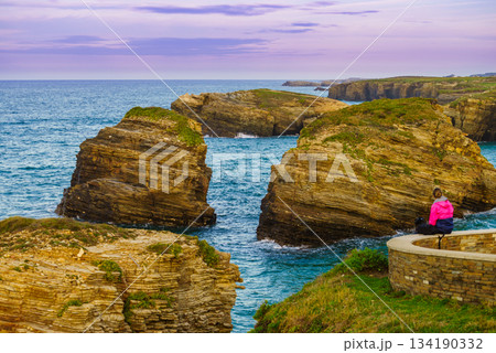 Woman visiting Cathedral Beach in Spain. 134190332