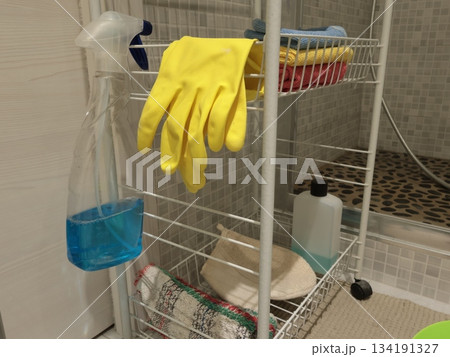 Rubber gloves and bathroom cleaning products on shelf. Health, cleanliness and hygiene. Interior design and furniture in modern flat. Rubber gloves and bathroom cleaning products on shelf. Health, cleanliness and hygiene. Interior design and furniture in modern flat. 134191327