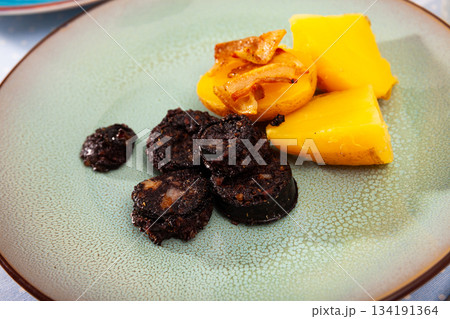 Fried rustic tasty blood sausage with potato served at plate Fried rustic tasty blood sausage with potato served at plate 134191364