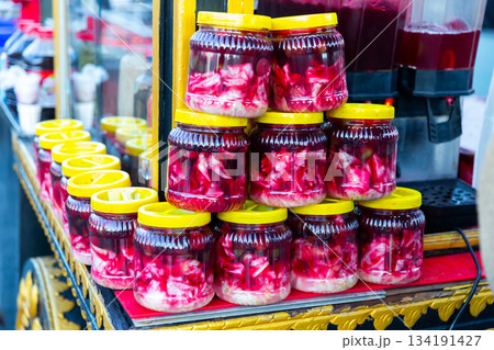 Glass jars with traditional Turkish pickles Salgam for sale 134191427