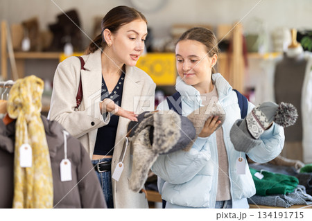 woman and her daughter choose hats woman and her daughter choose hats 134191715
