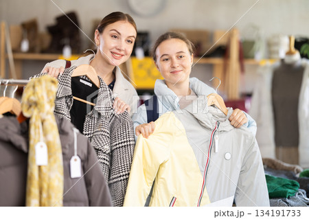 Adult woman and teenage girl choose outerwear Adult woman and teenage girl choose outerwear 134191733