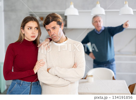 Old man quarreling with couple Old man quarreling with couple 134191856