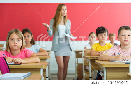 Group of school kids and teacher during lesson in classroom 134191945