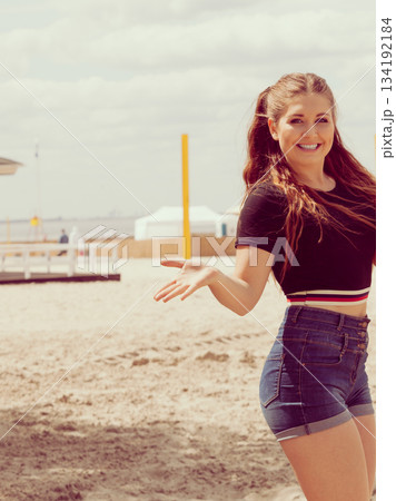 Young woman eating ice cream 134192184