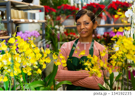 Portrait of a latin american woman florist in a flower shop 134192235