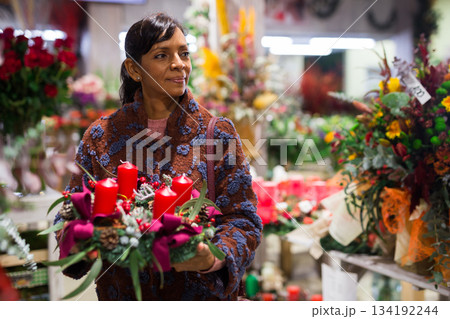 Woman buying New Year decor at flower shop 134192244