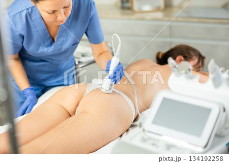 Professional beautician makes cryotherapy for rejuvenation woman body, anti aging procedure and shrink pores and repair damaged skin in salon Professional beautician makes cryotherapy for rejuvenation woman body, anti aging procedure and shrink pores and repair damaged skin in salon 134192258
