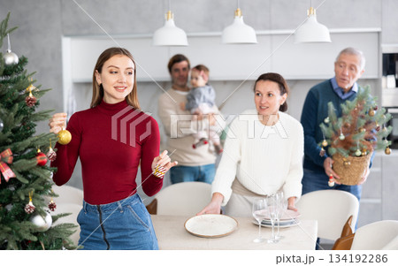 Woman decorating Christmas tree 134192286
