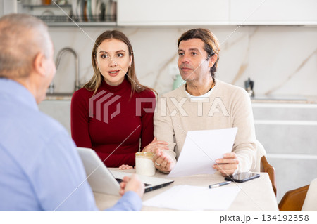 Agent making offer to couple Agent making offer to couple 134192358