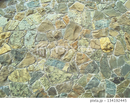 Paved wall with rough granite stones, texture background Paved wall with rough granite stones, texture background 134192445