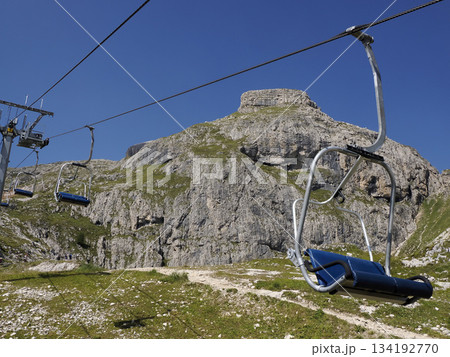 Chairlift in dolomites detail, summer season Chairlift in dolomites detail, summer season 134192770