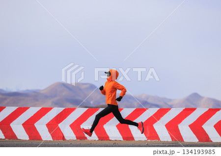 Fitness woman trail runner running on trail leading to Mount Everest in tibet, China 134193985