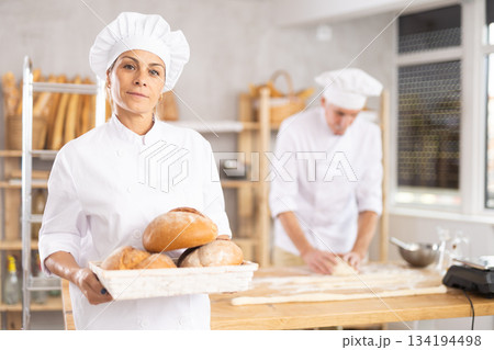Elderly woman with homemade bread in bakery Elderly woman with homemade bread in bakery 134194498