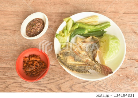 batter fried tilapia fish with boiled vegetable on plate dipping spicy shrimp paste sauce batter fried tilapia fish with boiled vegetable on plate dipping spicy shrimp paste sauce 134194831
