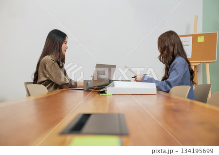 Busy office work people meet, business women team members review project documents, collaborating on market strategy, focused professionals achieving goals in modern conference room. Busy office work people meet, business women team members review project documents, collaborating on market strategy, focused professionals achieving goals in modern conference room. 134195699