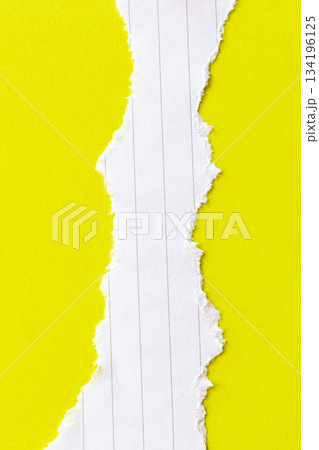 Ripped white paper with lined texture on a bright yellow background. The torn edge creates a contrast between the two colors. Ripped white paper with lined texture on a bright yellow background. The torn edge creates a contrast between the two colors. 134196125