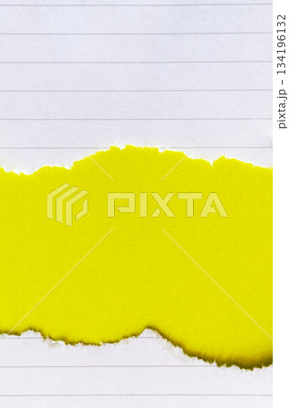 Ripped white paper with lined texture on a bright yellow background. The torn edge creates a contrast between the two colors. 134196132